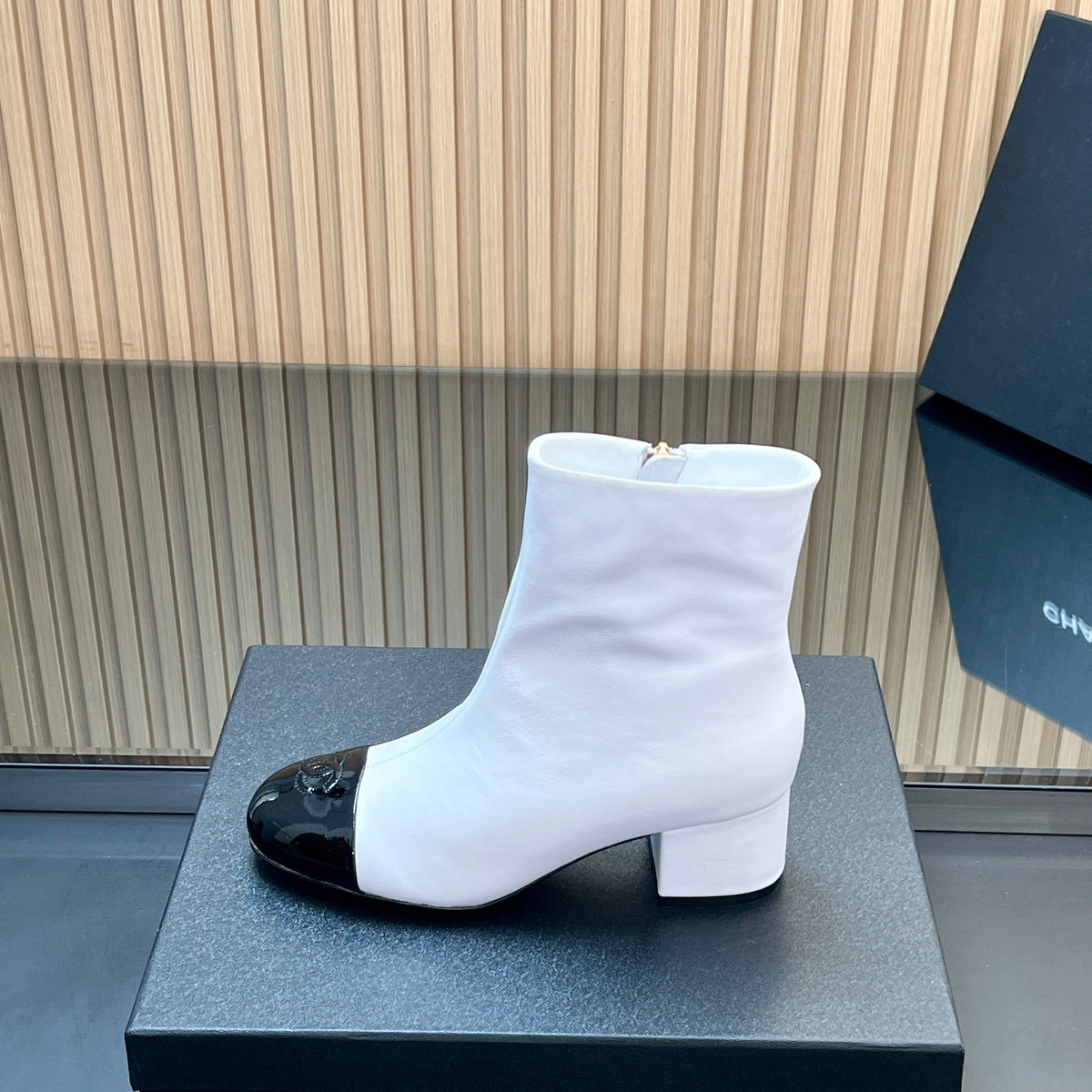 CHANEL 25S BOOTS WITH PATENT TOE CAP 50MM IN WHITE AND BLACK CALFSKIN